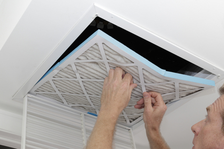 person removing dirty air filter